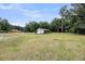 Large grassy backyard and a shed at 5056 Red Oak Rd, Cottageville, SC 29435