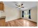 Sunny bedroom with wood-look floors, neutral walls, a window and a ceiling fan at 5056 Red Oak Rd, Cottageville, SC 29435