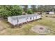 Single-story house with white siding and a fire pit in the spacious backyard at 5056 Red Oak Rd, Cottageville, SC 29435