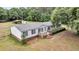 Charming single-story home with white siding, black shutters, and a cozy front deck at 5056 Red Oak Rd, Cottageville, SC 29435