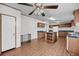 Open-concept kitchen features wood cabinets, an island, wood-look flooring, and stainless steel appliances at 5056 Red Oak Rd, Cottageville, SC 29435