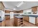 Spacious kitchen features blue countertops, wooden cabinets, a central island, and wood-look floors at 5056 Red Oak Rd, Cottageville, SC 29435