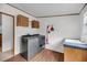 Utility room includes new washer and dryer, sink and wood look flooring at 5056 Red Oak Rd, Cottageville, SC 29435
