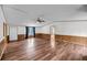 Spacious living room with wood paneling, ceiling fan, and hardwood floors at 5056 Red Oak Rd, Cottageville, SC 29435