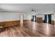 Spacious living room with wood paneling, ceiling fan, fireplace, and hardwood floors at 5056 Red Oak Rd, Cottageville, SC 29435