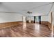 Spacious living room with wood paneling, ceiling fan, and hardwood floors at 5056 Red Oak Rd, Cottageville, SC 29435