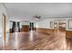 Spacious living room with wood paneling, ceiling fan, fireplace, and hardwood floors at 5056 Red Oak Rd, Cottageville, SC 29435