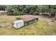 Outbuildings surrounded by lush greenery, with one partially covered in vines at 5056 Red Oak Rd, Cottageville, SC 29435