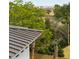 Scenic backyard view featuring lush greenery, palms and metal roof of home at 525 Old Bridge Ct, Mount Pleasant, SC 29464