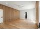 Expansive bedroom featuring wood accent wall, modern ceiling fan, and hardwood floors at 525 Old Bridge Ct, Mount Pleasant, SC 29464