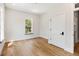 Bright bedroom featuring hardwood floors, a large window, and a door leading to the hallway at 525 Old Bridge Ct, Mount Pleasant, SC 29464