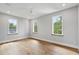 Spacious bedroom with hardwood floors and bright natural light from multiple windows at 525 Old Bridge Ct, Mount Pleasant, SC 29464