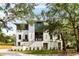 Elegant exterior elevation showcasing the home's brick facade, modern design, and manicured landscaping at 525 Old Bridge Ct, Mount Pleasant, SC 29464