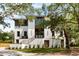 Beautiful exterior of the home featuring a manicured lawn, a brick facade, and mature landscaping at 525 Old Bridge Ct, Mount Pleasant, SC 29464
