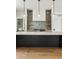Close up of a modern kitchen with a black island, elegant lighting, and tiled backsplash at 525 Old Bridge Ct, Mount Pleasant, SC 29464