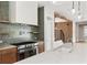 Modern kitchen boasting stylish backsplash, stainless steel appliances, and island with a sink at 525 Old Bridge Ct, Mount Pleasant, SC 29464
