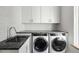 Laundry room with sleek marble countertops, stainless steel sink, and modern washer and dryer at 525 Old Bridge Ct, Mount Pleasant, SC 29464