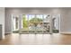 Bright living room with light hardwood floors and sliding glass doors that provide access to the beautiful outdoor pool at 525 Old Bridge Ct, Mount Pleasant, SC 29464