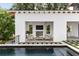 Outdoor pool area with a covered lounge, fireplace, TV, and lush landscaping at 525 Old Bridge Ct, Mount Pleasant, SC 29464