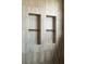 Modern shower with built-in shelving and elegant neutral-toned tile design at 525 Old Bridge Ct, Mount Pleasant, SC 29464