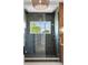 Walk-in shower with gray tile, glass enclosure, wood accent wall, and window overlooking the yard at 525 Old Bridge Ct, Mount Pleasant, SC 29464
