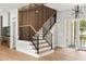 Modern staircase featuring wood and iron railings, complimented by wood accent wall and hanging fixture at 525 Old Bridge Ct, Mount Pleasant, SC 29464