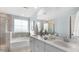 A bright bathroom featuring a large tub, a double sink vanity, and clean modern finishes at 527 Verdi Drive Dr, Summerville, SC 29486