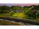 Scenic waterfront property with lush lawn, mature trees, and protective retaining wall at 528 Wampler Dr, Charleston, SC 29412