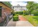 Brick and concrete walkway with green hedges and view of a large house at 528 Wampler Dr, Charleston, SC 29412