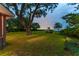Backyard with sprawling lawn and beautiful waterfront view at dusk at 528 Wampler Dr, Charleston, SC 29412
