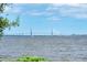 Scenic view of a modern suspension bridge spanning the waterway, framed by lush greenery and a clear blue sky at 528 Wampler Dr, Charleston, SC 29412