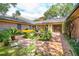 Charming brick courtyard with lush greenery, potted plants, and inviting outdoor seating area, perfect for relaxing at 528 Wampler Dr, Charleston, SC 29412