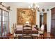 Elegant dining room featuring a large table, chandelier, and decorative tapestry, ideal for gatherings at 528 Wampler Dr, Charleston, SC 29412