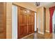 Elegant entryway with wooden double doors, textured wallpaper, and hardwood floors creating a warm welcome at 528 Wampler Dr, Charleston, SC 29412