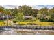 Brick home with manicured lawn and trees situated on the waterfront at 528 Wampler Dr, Charleston, SC 29412