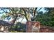 Charming brick home with an address marker set in a brick wall at the entrance of the driveway at 528 Wampler Dr, Charleston, SC 29412