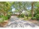 Traditional home with a two-car garage, brick accents, and mature trees along a spacious driveway at 528 Wampler Dr, Charleston, SC 29412