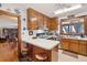 Cozy kitchen featuring wooden cabinets, breakfast bar seating, and ample natural light at 528 Wampler Dr, Charleston, SC 29412