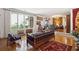 Bright living room featuring hardwood floors, large windows, and stylish vintage furnishings at 528 Wampler Dr, Charleston, SC 29412