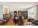 Open-concept living room with hardwood floors, bookshelves, fireplace, and bright natural light at 528 Wampler Dr, Charleston, SC 29412