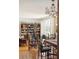 Open-concept living space with hardwood floors, built-in bookshelves, and vintage furniture at 528 Wampler Dr, Charleston, SC 29412