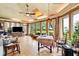 Bright sunroom with brick accents, multiple windows, and a ceiling fan at 528 Wampler Dr, Charleston, SC 29412