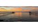 Sunrise or sunset water view showing the long dock and pier at 528 Wampler Dr, Charleston, SC 29412