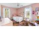 Cozy pink bedroom with hardwood floors, single bed, and lots of natural light from the windows at 532 Sunset Dr, Charleston, SC 29407