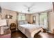 Bedroom with a queen bed, wood floors, neutral walls, and two windows with floral curtains at 532 Sunset Dr, Charleston, SC 29407