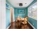 Dining area featuring blue walls, wood floors, and a round table with seating for six at 532 Sunset Dr, Charleston, SC 29407