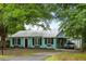 Charming home featuring a metal roof, updated windows, and a welcoming covered parking area at 532 Sunset Dr, Charleston, SC 29407