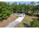 Charming single-story home with lush green surroundings and a long private driveway at 5774 Scott White Rd, Hollywood, SC 29449