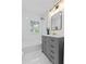 Stylish bathroom with a gray vanity, gold fixtures, and a shower-tub combo at 5774 Scott White Rd, Hollywood, SC 29449