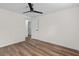 Bedroom features door, ceiling fan, and wood floors at 5774 Scott White Rd, Hollywood, SC 29449